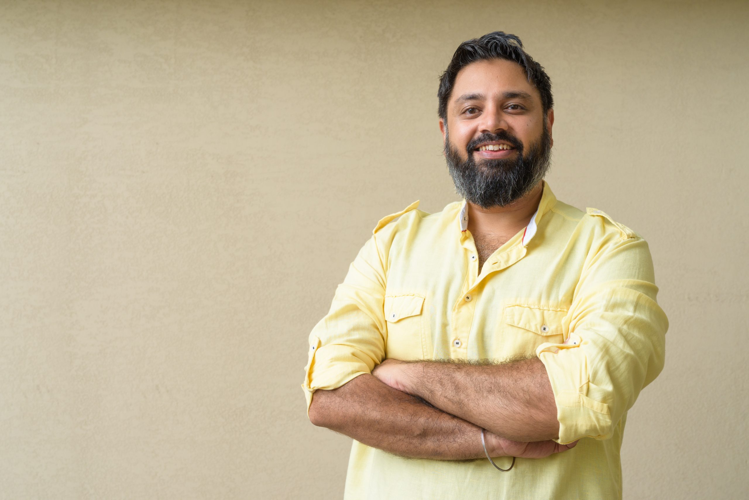 portrait-of-handsome-bearded-indian-man-against-pl-2026-01-08-05-53-02-utc